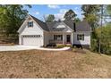 Charming home featuring a white exterior, covered porch, attached garage, and well-manicured lawn at 869 Kathryn Se Dr, Concord, NC 28025