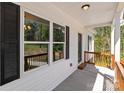 Cozy covered porch with wood railing, offering a welcoming entrance to the home with natural light at 869 Kathryn Se Dr, Concord, NC 28025