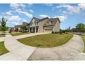 Well-maintained two-story home with a manicured lawn and a long driveway, set in a peaceful neighborhood at 11234 Smokethorn Nw Dr, Concord, NC 28027