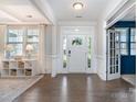Bright foyer with hardwood floors, decorative moldings, and a view into a sunny front room at 11234 Smokethorn Nw Dr, Concord, NC 28027