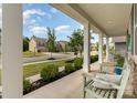 Inviting front porch with comfortable seating, perfect for relaxing and enjoying the neighborhood views at 11234 Smokethorn Nw Dr, Concord, NC 28027