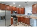 Galley kitchen offers stainless steel appliances, ample wood cabinets, and light countertops at 12036 Duke Lancaster Dr, Charlotte, NC 28277