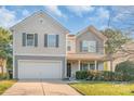 Inviting two-story home featuring a well-kept lawn and an attached two-car garage at 1219 Century Dr, Clover, SC 29710