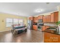 Eat-in kitchen area showcases a modern dining table, stainless steel appliances, and wood flooring at 1219 Century Dr, Clover, SC 29710