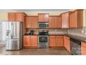 A well-equipped kitchen boasts stainless steel appliances, granite countertops, and wood cabinets at 1219 Century Dr, Clover, SC 29710