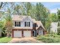 Two-story home with brick and siding exterior, attached garage, and mature trees at 1432 Deer Forest Dr, Fort Mill, SC 29707