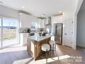 Bright kitchen with an island, stainless steel appliances, white cabinets, and natural light at 1525 Solitude Ct, Kannapolis, NC 28081