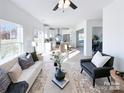 Open concept living room featuring modern furnishings and natural light with view to the kitchen at 1525 Solitude Ct, Kannapolis, NC 28081