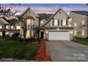 Charming two-story home featuring brick and siding exterior, a two-car garage, and a well-manicured front yard at 15814 Herring Gull Way, Charlotte, NC 28278