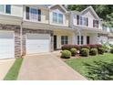 Charming townhouse exterior featuring stone accents, attached garage, and manicured landscaping at 168 Limerick Rd # C, Mooresville, NC 28115