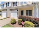 Well-kept townhouse with stone details, an attached garage, and a landscaped yard at 168 Limerick Rd # C, Mooresville, NC 28115