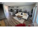 Open-concept living room with modern decor, wood flooring, and a view of the kitchen area at 1843 Old Rivers Rd # 209, Concord, NC 28027