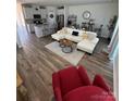 Spacious living room with a large sectional, wood flooring, and neutral decor at 1843 Old Rivers Rd # 209, Concord, NC 28027