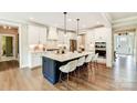 Spacious kitchen featuring a large island with seating, white cabinets, and stainless steel appliances at 2009 Autumn Dr # 2, Monroe, NC 28110