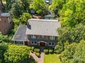 Aerial view of brick home with a large roof, surrounded by trees and well-maintained landscaping at 208 Park Ave, Wadesboro, NC 28170