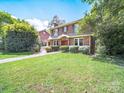 Traditional brick home with manicured lawn and lush landscaping, a welcoming suburban residence at 208 Park Ave, Wadesboro, NC 28170
