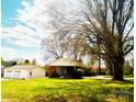 Full view of the home and detached garage with a large lawn at 215 E K St, Newton, NC 28658