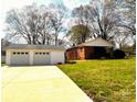 Detached garage and exterior of home with a large lawn at 215 E K St, Newton, NC 28658