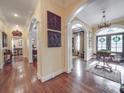 Elegant hallway with arched openings, hardwood floors, and decorative wall panels at 3667 Saint Andrews Ln, Gastonia, NC 28056