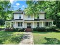 Beautiful two-story home with an inviting wrap-around porch and manicured lawn at 407 Chesterfield Ave, Lancaster, SC 29720