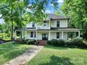 Charming two-story home featuring a spacious porch and well-maintained landscaping at 407 Chesterfield Ave, Lancaster, SC 29720
