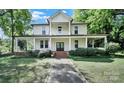 Beautiful two-story home with an inviting wrap-around porch and manicured lawn at 407 Chesterfield Ave, Lancaster, SC 29720