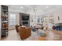 Bright and airy living room with fireplace, decorative ceiling, and hardwood flooring at 4412 Foxview Ct, Charlotte, NC 28270