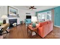 Bright living room with hardwood flooring, fireplace, ceiling fan, and large windows at 5039 Folly Ln, Fort Mill, SC 29707