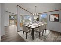 Inviting dining room with stylish chandelier and large windows, adjacent to the living area at 5110 Old Still Ln, Bessemer City, NC 28016