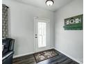 Bright foyer featuring a decorative glass door, wood floors, and a stylish coat rack for added convenience at 517 Bertram Rd, Fort Mill, SC 29708