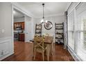 Bright dining room with wood floors and large window at 5216 Berkeley View Cir, Charlotte, NC 28277