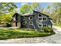 Contemporary home with a striking angular roofline, large windows, and beautiful landscaping at 5416 Woodcreek Dr, Charlotte, NC 28226