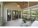 Relaxing screened porch showcasing comfortable seating, stylish rug, and serene views of the surrounding landscape at 5416 Woodcreek Dr, Charlotte, NC 28226