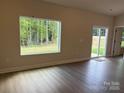 A light-filled living room featuring wood flooring and a view to the outdoors at 5711 Skinny Dr, Charlotte, NC 28215