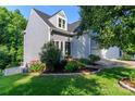 View of the home's siding and manicured front lawn, sidewalk and small privacy fence at 6013 Coaching Inn Ct, Charlotte, NC 28270