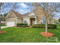 Beautiful single-Gathering home featuring a manicured lawn and a well-maintained exterior at 7371 Vanguard Ct, Stanley, NC 28164