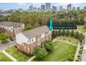Aerial view of townhome with skyline backdrop and community green space at 791 Seigle Point Dr, Charlotte, NC 28204