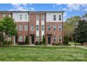 Modern brick townhome featuring three stories, multiple windows, and well-maintained landscaping in a green lawn at 791 Seigle Point Dr, Charlotte, NC 28204