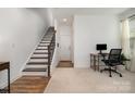Open living space with stairs, a dedicated workspace, and neutral decor at 791 Seigle Point Dr, Charlotte, NC 28204
