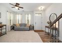 Bright living room featuring neutral carpet, hardwood-style floors, and a staircase at 791 Seigle Point Dr, Charlotte, NC 28204