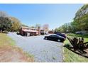 Spacious backyard with parking area and covered deck and access to the house at 9716 Sunway Dr, Mint Hill, NC 28227