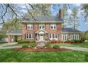 Charming brick home with meticulously landscaped front yard, inviting walkway, and classic architectural details at 10 North Rd, Salisbury, NC 28144