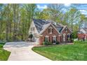 Brick home with a long driveway and attached two car garage at 125 Cove Creek Loop # 18, Mooresville, NC 28117