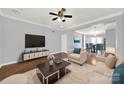 Bright living room featuring hardwood floors, a ceiling fan, and an open floor plan at 13376 Calloway Glen Dr, Charlotte, NC 28273