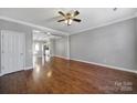 Hardwood floored living room featuring an open concept layout connecting to the adjacent kitchen at 13376 Calloway Glen Dr, Charlotte, NC 28273