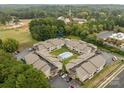Beautiful aerial view of condos surrounding a community pool with mature trees and parking at 140 Lake Concord Ne Rd # D-1, Concord, NC 28025