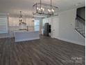 Bright and airy open concept living space with a contemporary kitchen and stylish light fixtures at 1939 Hendricks St, Rock Hill, SC 29732