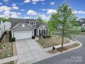 Beautiful aerial view of home featuring manicured lawn, landscaping, and driveway on a sunny day at 20202 Dovekie Ln, Indian Land, SC 29707
