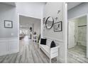 Bright hallway with hardwood flooring, modern decor, and views into the living room at 20202 Dovekie Ln, Indian Land, SC 29707