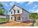 Exterior view of a two-story home under construction, showcasing the building wrap, framing, and front porch detail at 2628 S Main St, Kannapolis, NC 28027